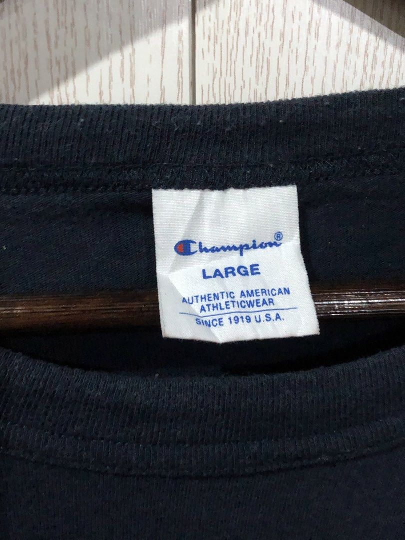 Champion Curved Logo Tee Dark Blue Large (Category: Shirts) located in Magsaysay. Submitted by ryns_thrifting (Listing ID 1466260854, Image 2). Description: - Brand: Champion - Color: Dark Navy Blue - Size: Large - Material: 100% Cotton - Details: Distressed arch logo on chest, embroidered C logo on sleeve - Fit: Standard crewneck - Condition: Classic casual streetwear, easy to style.