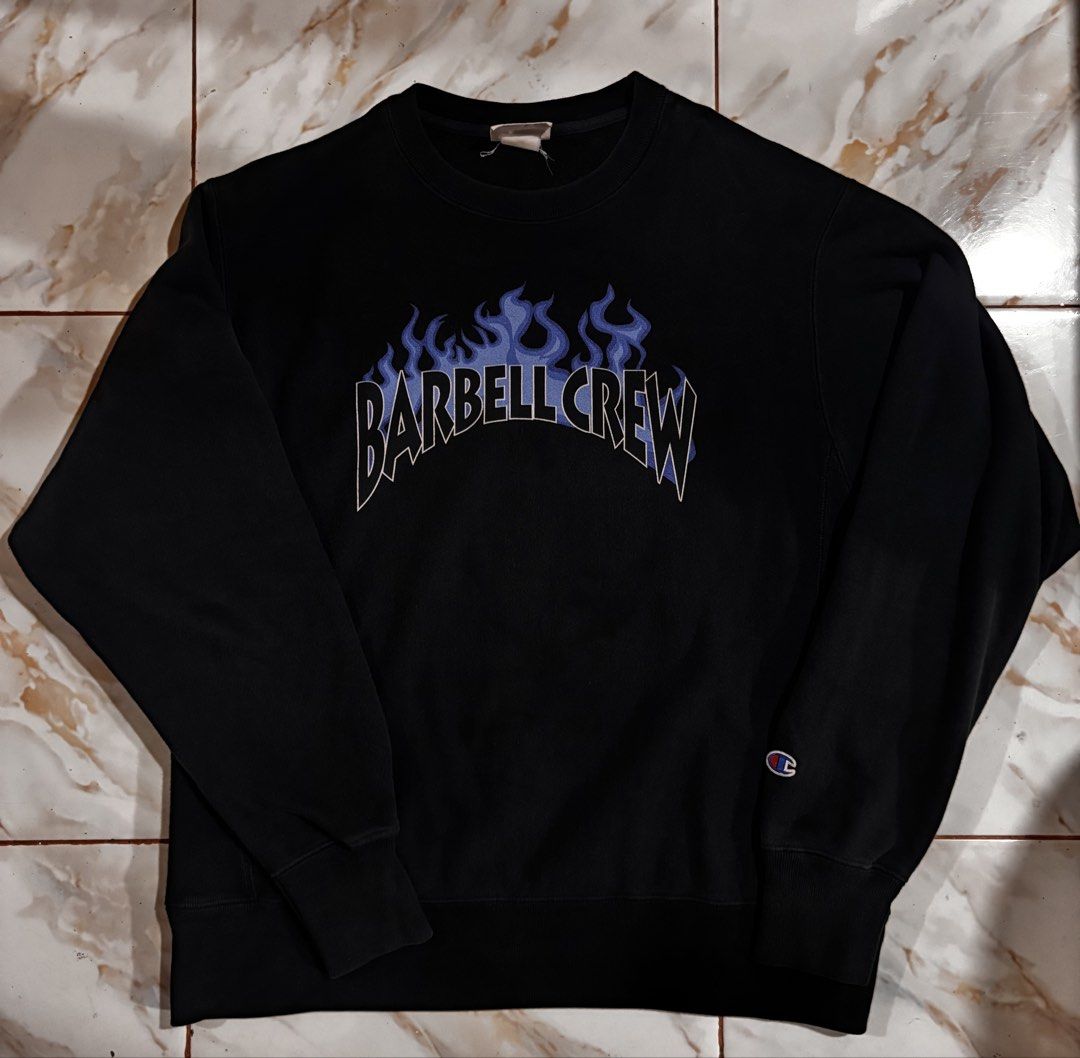 Champion Reverse Weave Barbell Crew Flame Sweatshirt Black Medium (Category: Coats, Jackets and Outerwear) located in Dumaguete. Submitted by revillahar03975 (Listing ID 1466328968, Image 2). Description: - Brand/Model: Authentic Champion Reverse Weave Sweatshirt - Size: Medium - Color: Black - Design: Blue flame graphic with 'Barbell Crew' lettering on front, classic Champion logo patch on left cuff - Material: Thick, warm cotton blend - Details