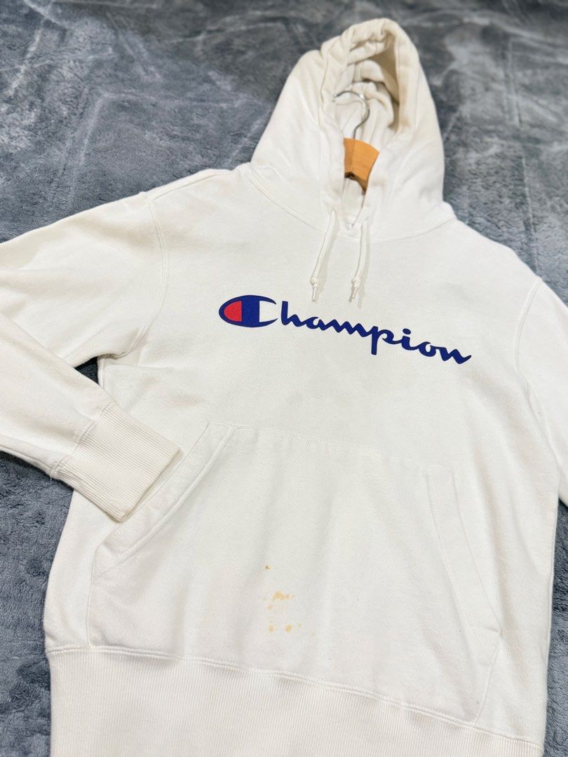 Champion Script Logo White Hoodie Size Small (Category: Hoodies) located in Manila. Submitted by yeti_it (Listing ID 1466159048, Image 2). Description: - Brand: Champion - Item: Classic Script Logo Hoodie - Color: White - Size: Small - Features: Adjustable drawstring hood, front kangaroo pocket, soft fleece interior, ribbed cuffs and hem - Condition: Pre-loved, with noticeable light brownish stains near the bottom pocket area (please check photos