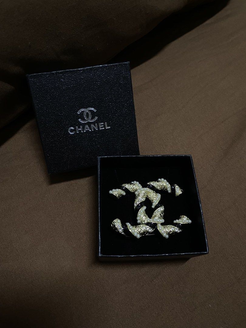 Chanel Brooch (Category: Luxury Accessories) located in Manila. Submitted by xielega (Listing ID 1466332391, Image 1). Description: Chanel CC Brooch featuring the iconic interlocking CC logo with black enamel, faux pearls, and crystal accents. Gold-tone finish with secure pin closure. Hallmarked "CHANEL - Made in France." Pre-owned and in very good condition with minor signs of wear on the back. Elegant accessory for blazers, dresses, scarves, ha