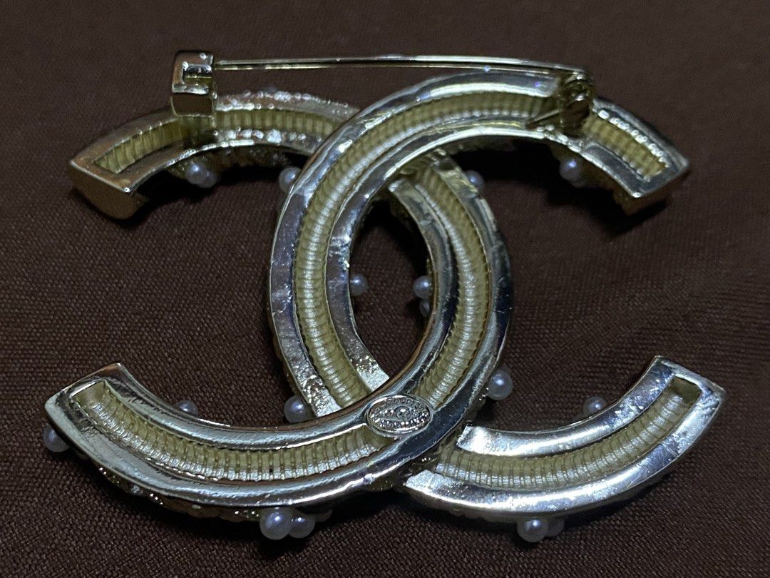 Chanel Brooch (Category: Luxury Accessories) located in Manila. Submitted by xielega (Listing ID 1466332391, Image 3). Description: Chanel CC Brooch featuring the iconic interlocking CC logo with black enamel, faux pearls, and crystal accents. Gold-tone finish with secure pin closure. Hallmarked "CHANEL - Made in France." Pre-owned and in very good condition with minor signs of wear on the back. Elegant accessory for blazers, dresses, scarves, ha