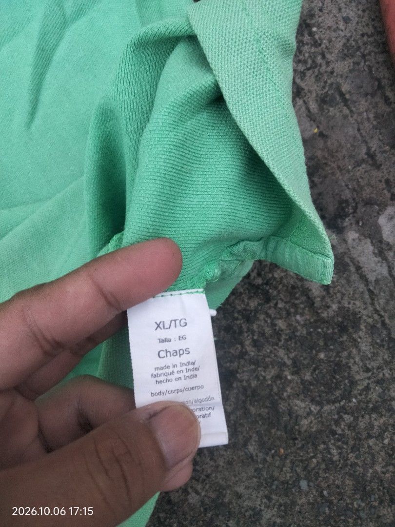 Chaps Green Polo Shirt (Category: Tshirts & Polo Shirts ) located in Caloocan City. Submitted by haruconcep52476 (Listing ID 1461060917, Image 3). Description: Dimensions W22×L30 Good condition Color rate 9 Issue dots stain - Classic green Chaps polo shirt - Short sleeves for comfort - Features a collar and a two-button neckline - Subtle Chaps logo embroidered on the chest - Ideal for everyday casual wear.