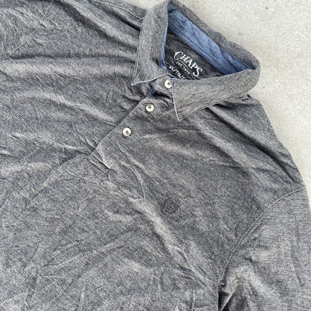 Chaps Grey Long Sleeve Polo Shirt (Category: Tshirts & Polo Shirts ) located in General Mariano Alvarez. Submitted by aaronatas819577 (Listing ID 1466161619, Image 3). Description: - Brand: Chaps - Size: XL - Color: Grey with blue inner collar trim - Material: Soft heathered fabric - Details: Classic collar, 3-button placket, and subtle embroidered chest logo - Condition: Great basic piece for layering or casual wear.