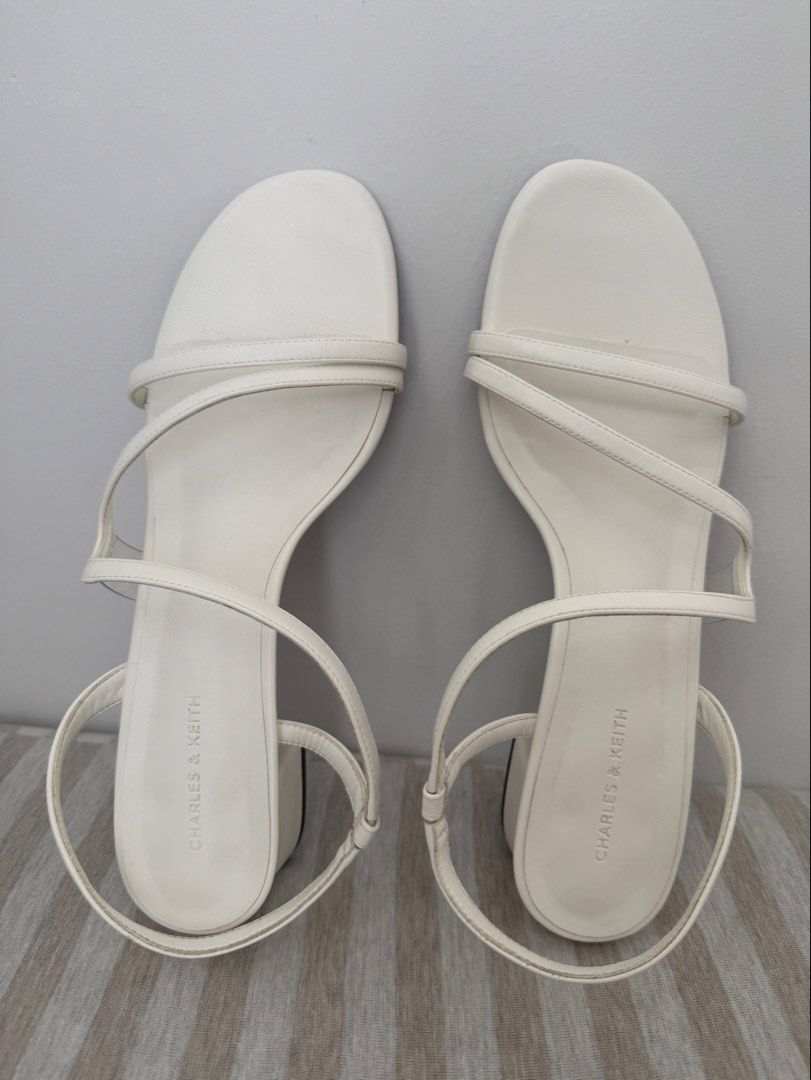 Charles & Keith Arden Chalk Sandals Size 40 (Category: Heels) located in Manila. Submitted by mollichie (Listing ID 1466217970, Image 1). Description: Charles & Keith Arden sandals in chalk white. Open toe design with multiple thin straps and a back strap. Chunky low block heel. Size 40. Original shoe box included. Only used once on my Civil Wedding..