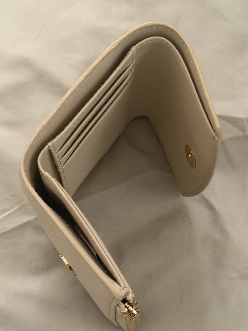 Charles & Keith Beige Trifold Wallet (Category: Wallets & Card holders) located in Las Pinas. Submitted by idontneedtheseanm (Listing ID 1466173761, Image 3). Description: - Brand: Charles and Keith - Color: Beige with textured finish - Hardware: Elegant gold-tone hardware and zipper pull - Closure: Secure snap button closure - Interior: Multiple card slots and a dedicated coin compartment - Size: Compact, fits easily into small bags - Condition: