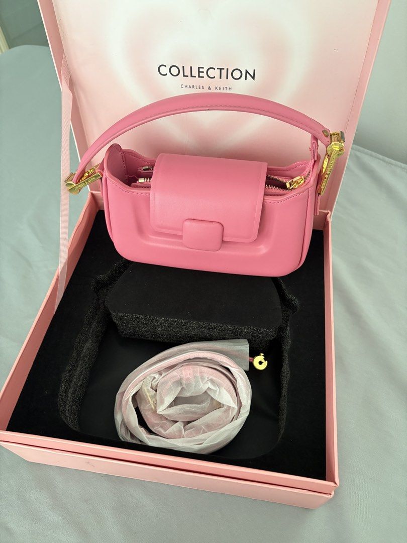 Charles & Keith Koa Push-Lock Top Handle Bag (Category: Shoulder Bags) located in Caloocan City. Submitted by lovedbymex (Listing ID 1466238427, Image 3). Description: - Brand: Charles & Keith (Special Collection) - Color & Material: Bright pink smooth leather with gold-tone hardware - Closure: Front flap with clasp and zippered top opening - Condition: never used but with minor handling - Inclusions: Original pink gift box, short strap and extra