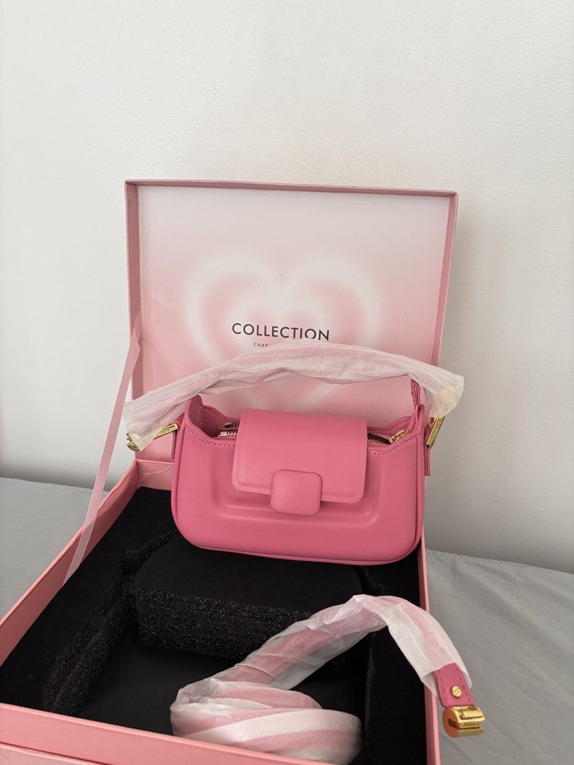 Charles & Keith Koa Push-Lock Top Handle Bag (Category: Shoulder Bags) located in Caloocan City. Submitted by lovedbymex (Listing ID 1466238427, Image 2). Description: - Brand: Charles & Keith (Special Collection) - Color & Material: Bright pink smooth leather with gold-tone hardware - Closure: Front flap with clasp and zippered top opening - Condition: never used but with minor handling - Inclusions: Original pink gift box, short strap and extra