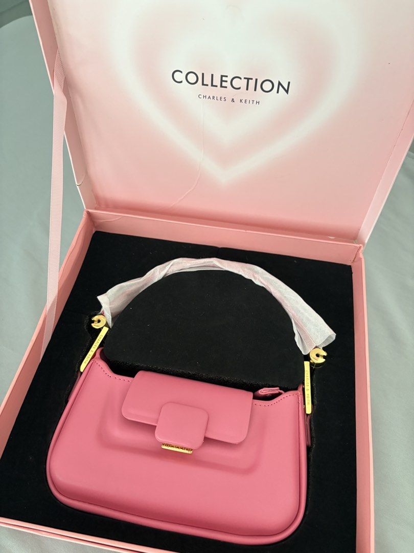 Charles & Keith Koa Push-Lock Top Handle Bag (Category: Shoulder Bags) located in Caloocan City. Submitted by lovedbymex (Listing ID 1466238427, Image 1). Description: - Brand: Charles & Keith (Special Collection) - Color & Material: Bright pink smooth leather with gold-tone hardware - Closure: Front flap with clasp and zippered top opening - Condition: never used but with minor handling - Inclusions: Original pink gift box, short strap and extra