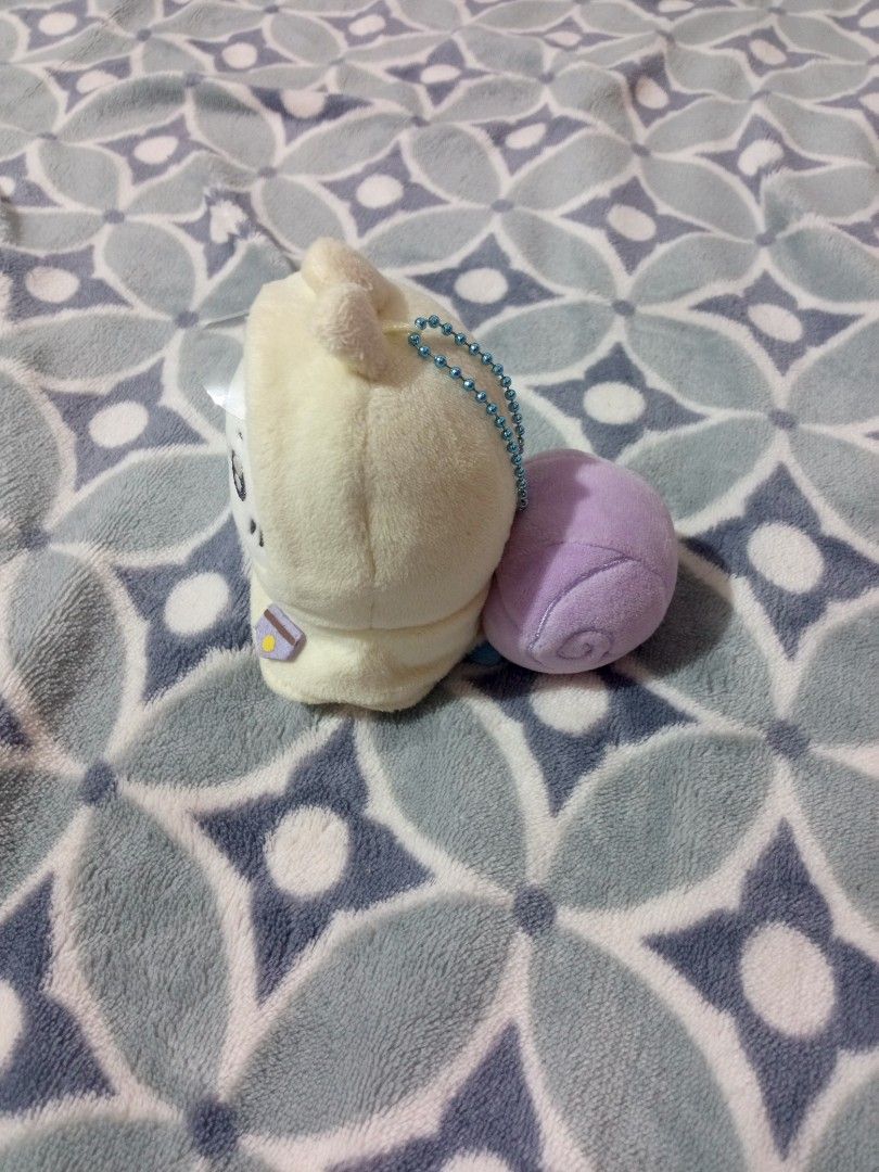 Chiikawa Snail Costume Plush Keychain (Category: Plushies & Soft Toys) located in Cateel. Submitted by neoo_c (Listing ID 1466244756, Image 3). Description: - Authentic Chiikawa plush mascot - Adorable design: Dressed in a cream snail hoodie with a purple shell - Features a cute embroidered face, whiskers, and rosy cheeks - Equipped with a blue ball chain for easy hanging on bags or keys - Fluffy, clean, and well-maintained fabric - Perfect for C