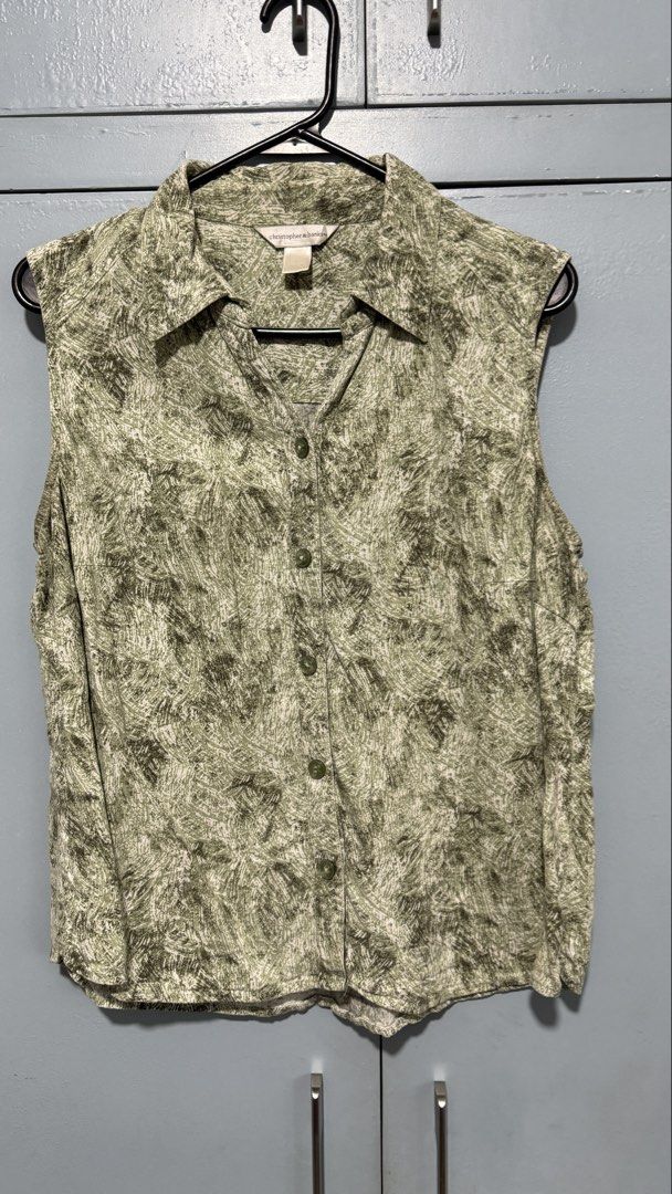 Christopher & Banks Green Sleeveless Button-Down Shirt (Category: Sleeveless) located in Quezon City. Submitted by amogz (Listing ID 1466325114, Image 1). Description: Chic green patterned sleeveless shirt by Christopher & Banks. Features a button-down front, collar, and lightweight abstract print. Perfect for warm weather!.