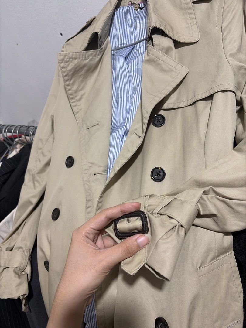 Classic Trench Coat in Deep Beige (Category: Coats, Jackets and Outerwear) located in Taguig. Submitted by vm.co (Listing ID 1466320823, Image 3). Description: Classic Trench Coat 🤎 Knee-length • Double-breasted • Leather buckle wrist detail Structured trench coat fabric with a classic, polished finish..