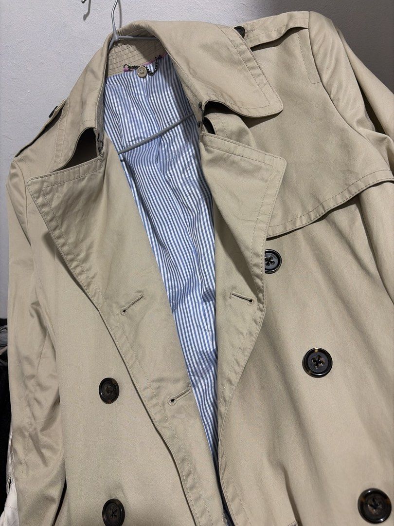 Classic Trench Coat in Deep Beige (Category: Coats, Jackets and Outerwear) located in Taguig. Submitted by vm.co (Listing ID 1466320823, Image 2). Description: Classic Trench Coat 🤎 Knee-length • Double-breasted • Leather buckle wrist detail Structured trench coat fabric with a classic, polished finish..