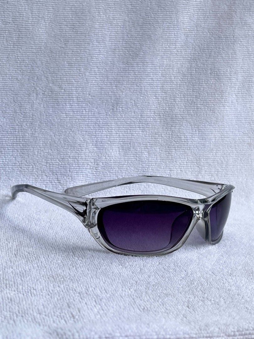 Clear Frame Sunglasses with Dark Gradient Lenses (Category: Sunglasses & Eyewear) located in Manila. Submitted by quin.tiphanie15 (Listing ID 1466233335, Image 1). Description: - Clear plastic frames with a sporty wrap-around design - Dark purple gradient lenses providing sun protection - Thick temples with a minimalist, versatile look - Lightweight and comfortable for all-day wear Payment first!.