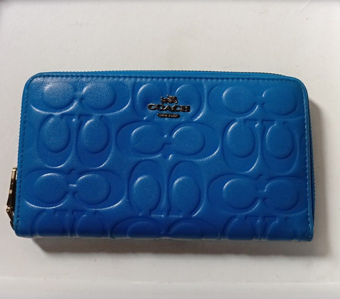 COACH ACCORDION LONG ZIP WALLET (Category: Luxury Bags & Wallets) located in Manila. Submitted by eriiicaspage (Listing ID 1466157716, Image 2). Description: PREOWNED LIKENEW Coach wallet featuring the iconic debossed signature C pattern - Elegant gold-tone hardware with metal logo accent on the front - Secure zip-around closure to keep your essentials safe - Well-organized interior with multiple card slots, slip compartments, and a zippered coin