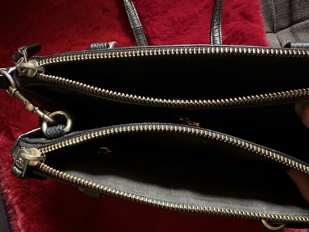 Coach Black Leather Crossbody Handbag (Category: Luxury Bags & Wallets) located in Quezon City. Submitted by shopaholic.kart2021 (Listing ID 1466235979, Image 3). Description: - Brand: Coach - Color: Classic Black - Material: Genuine Leather with fabric lining - Design: Structured shape with dual zippered compartments - Accessories: Includes matching black leather hangtag - Features: Top carry handles plus rings for strap attachment (strap not in