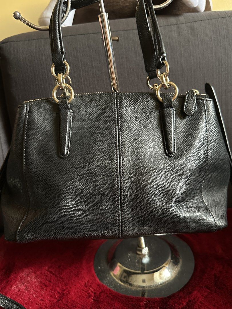 Coach Black Leather Crossbody Handbag (Category: Luxury Bags & Wallets) located in Quezon City. Submitted by shopaholic.kart2021 (Listing ID 1466235979, Image 1). Description: - Brand: Coach - Color: Classic Black - Material: Genuine Leather with fabric lining - Design: Structured shape with dual zippered compartments - Accessories: Includes matching black leather hangtag - Features: Top carry handles plus rings for strap attachment (strap not in