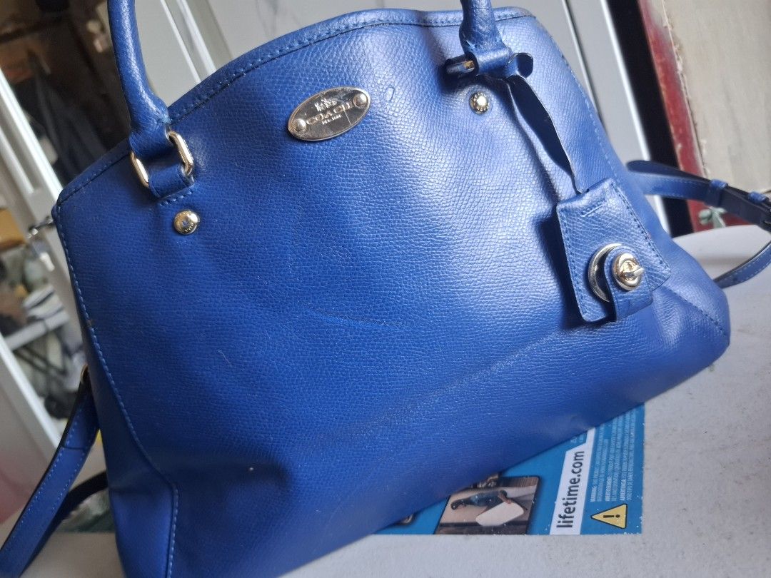 Coach Blue Leather Handbag (Category: Luxury Bags & Wallets) located in Marikina City. Submitted by bags21.ph (Listing ID 1466335773, Image 1). Description: - Authentic Coach handbag in a stunning bright blue pebbled leather - Dual top handles and a detachable shoulder strap for versatile styling - Elegant gold-tone hardware and front logo plaque - Secure zip-top closure with matching blue fabric-lined interior and multiple pockets - Includes mat