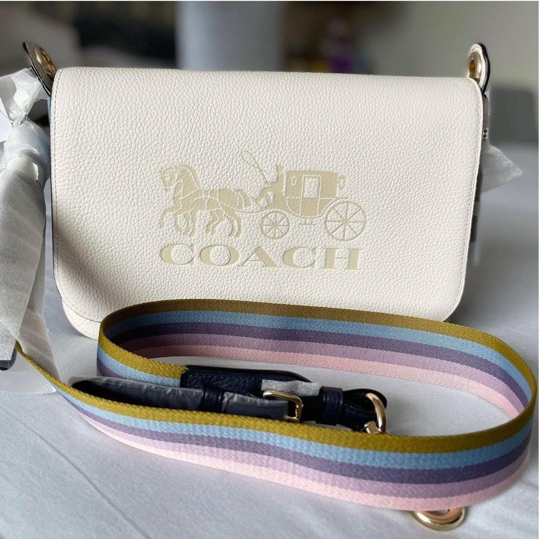 Coach Jes Leather Crossbody Bag (Category: Luxury Bags & Wallets) located in Manila. Submitted by flojo1220 (Listing ID 1466215168, Image 1). Description: Authentic Coach jes crossbody bag in white pebble leather with embossed horse and carriage logo on the front flap. Blue and purple side panels, tan lining inside with slip pocket. Includes a multi-colored striped fabric shoulder strap with gold-tone hardware. Hardware and hangtag still wrapped 