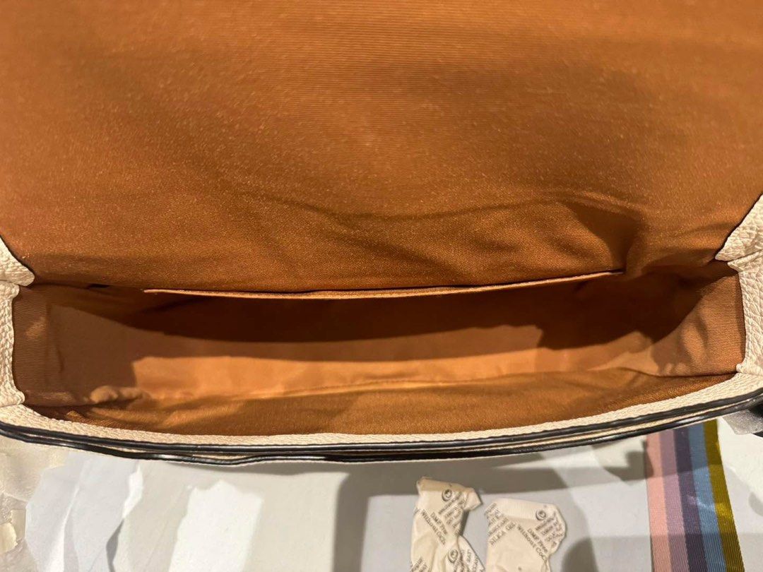 Coach Jes Leather Crossbody Bag (Category: Luxury Bags & Wallets) located in Manila. Submitted by flojo1220 (Listing ID 1466215168, Image 2). Description: Authentic Coach jes crossbody bag in white pebble leather with embossed horse and carriage logo on the front flap. Blue and purple side panels, tan lining inside with slip pocket. Includes a multi-colored striped fabric shoulder strap with gold-tone hardware. Hardware and hangtag still wrapped 