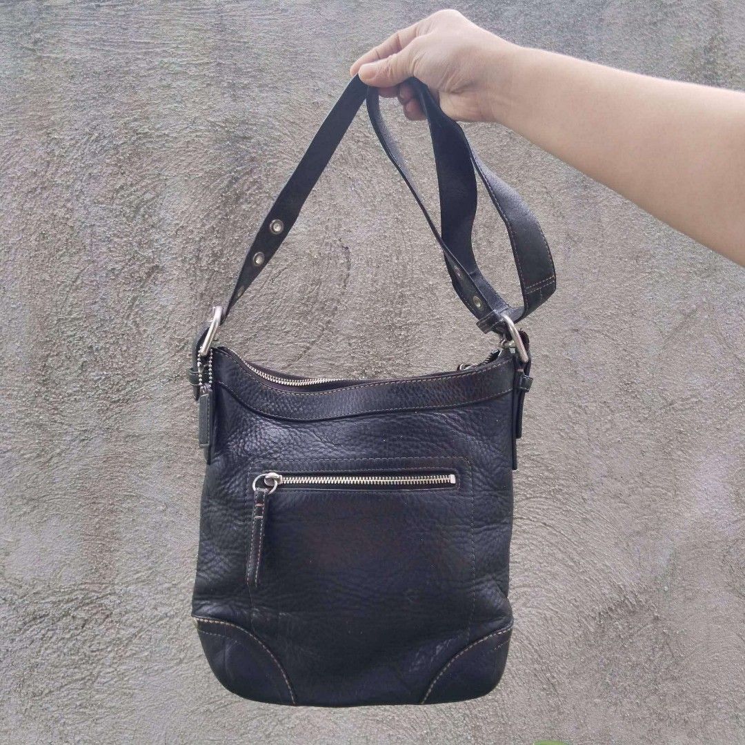Coach Leather Shoulder Bag Black (Category: Luxury Bags & Wallets) located in Lubao. Submitted by dione_closet503 (Listing ID 1466212461, Image 1). Description: - Brand: Coach - Material: Genuine black leather with pebbled texture - Hardware: Silver-tone - Closure: Secure top zip - Exterior: Front zippered pocket and classic hanging leather hangtag - Interior: Spacious compartment for daily essentials - Details: Dark brown contrast stitching alon