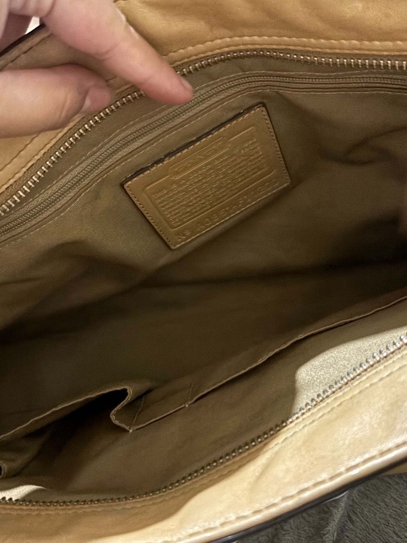 Coach Leather Tote Bag Yellow Tan (Category: Luxury Bags & Wallets) located in Taguig. Submitted by wonyjg (Listing ID 1466161531, Image 3). Description: Coach yellow leather tote bag with silver tone hardware and buckle strap detail across the front. Dual shoulder straps, protective metal feet on the bottom. Interior fabric lining includes a zippered pocket and slip pockets. Coach creed patch stamped inside with serial number. Classic structured