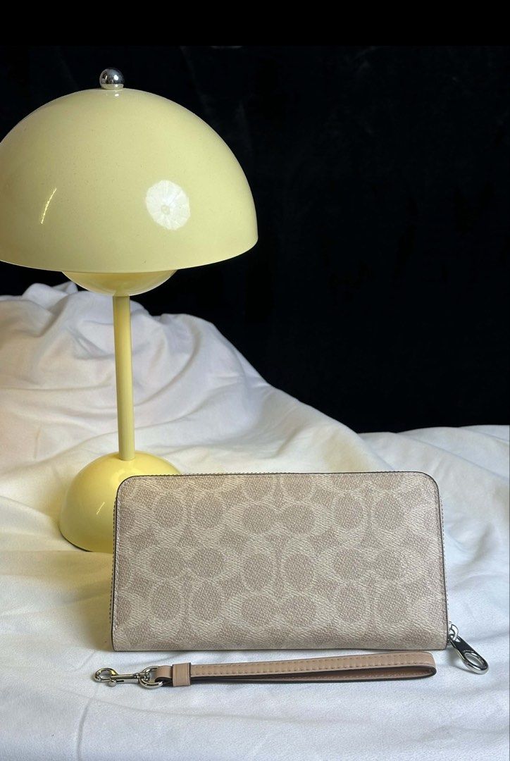 Coach Long Wallet in Sand Taupe (Category: Wallets & Card holders) located in Balagtas. Submitted by venta.shop (Listing ID 1466334376, Image 3). Description: New and original Comes with poly plastic, tag, care card and chip Detachable strap Can fit phone Multiple card slot Has zipper for coins and full length bill Simple yet elegant! ✨.
