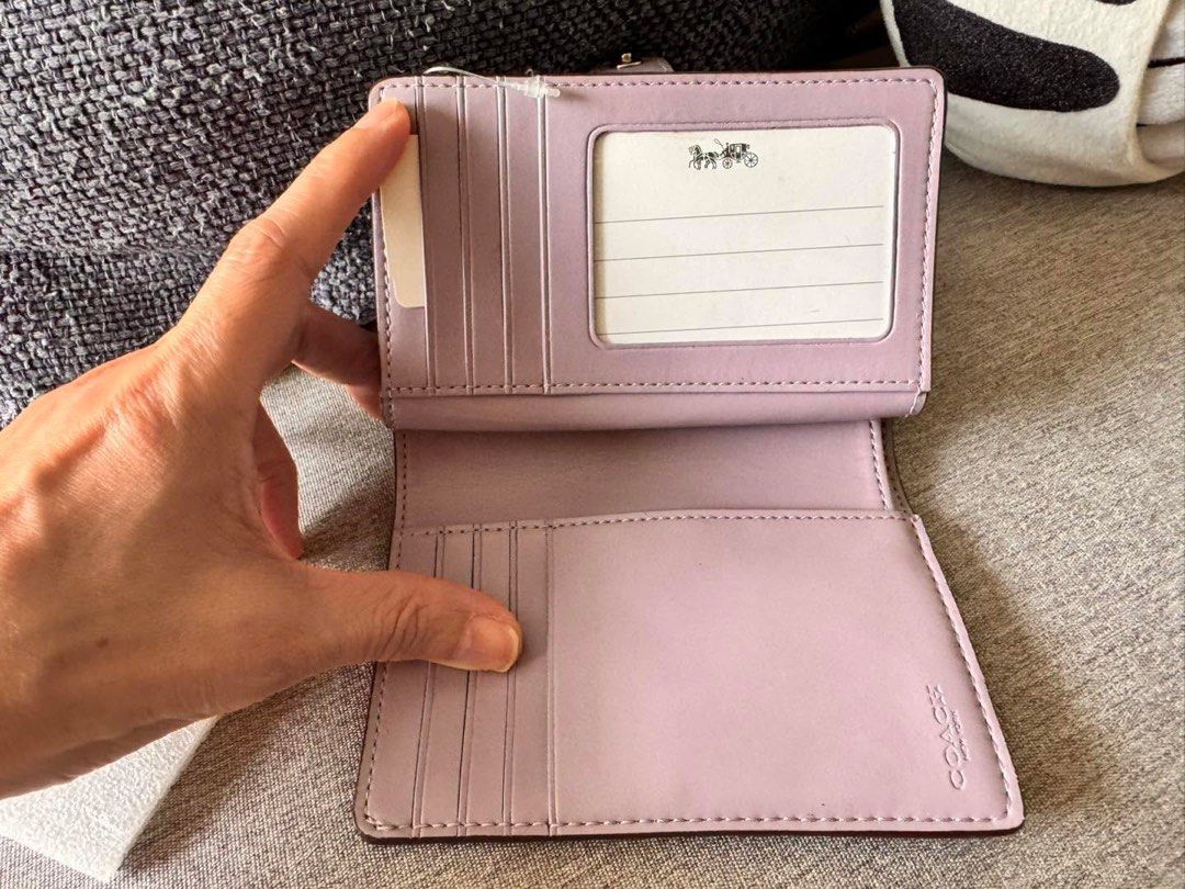 Coach Medium Corner Zip Wallet F23553 (Category: Wallets & Card holders) located in Manila. Submitted by flojo1220 (Listing ID 1466216499, Image 2). Description: - Brand new with original store tag and internal protectors - Authentic Coach Wallet F23553 - Signature khaki PVC with stylish lilac leather trim - Secure snap closure for main compartment - Multiple card slots, ID window, and full-length bill compartment - Handy zip coin pocket on the s