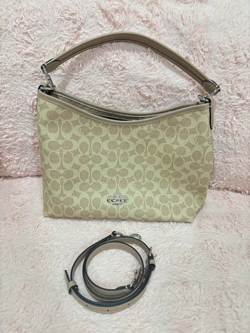 Coach Signature Canvas Shoulder Bag (Category: Luxury Bags & Wallets) located in Manila. Submitted by lil.moonxx (Listing ID 1466332194, Image 1). Description: - Authentic Coach shoulder bag in signature C coated canvas with light brown leather trim - Elegant silver-tone hardware and secure zip top closure - Clean fabric-lined interior featuring one zippered pocket and one slip pocket - Versatile carry options with a short top handle and a detach