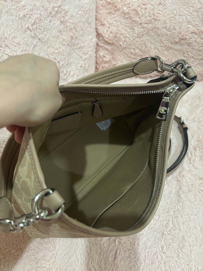 Coach Signature Canvas Shoulder Bag (Category: Luxury Bags & Wallets) located in Manila. Submitted by lil.moonxx (Listing ID 1466332194, Image 3). Description: - Authentic Coach shoulder bag in signature C coated canvas with light brown leather trim - Elegant silver-tone hardware and secure zip top closure - Clean fabric-lined interior featuring one zippered pocket and one slip pocket - Versatile carry options with a short top handle and a detach
