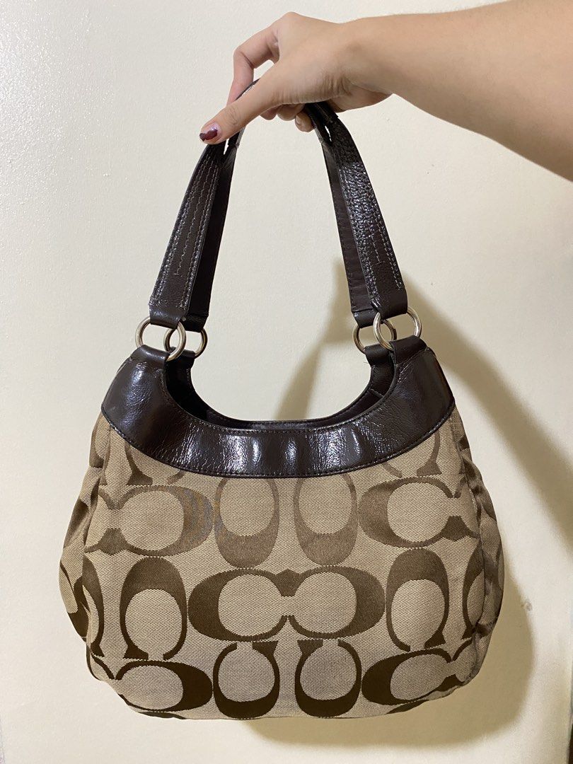 Coach Signature Hobo Shoulder Bag (Category: Shoulder Bags) located in Lapu Lapu. Submitted by yeldeclutters_ (Listing ID 1466201832, Image 2). Description: very minimal flaws, just small dirt at the bottom part 8.5 to 9/10 condition dm for details.