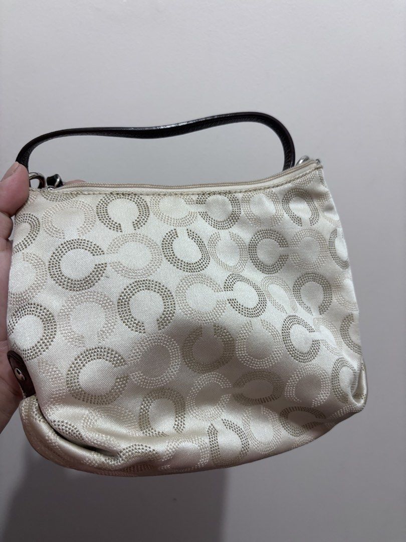 Coach Signature Optic C Small Hobo Bag (Category: Luxury Bags & Wallets) located in Caloocan City. Submitted by stuff_shop (Listing ID 1466293215, Image 2). Description: Coach monogram hobo bag in cream and beige fabric. Dark brown patent leather trim, strap, and Coach logo plaque on the front. Silver-tone hardware. Includes a detachable dark brown strap to wear as a shoulder bag or crossbody. Small Coach leather hangtag attached by a beaded chai