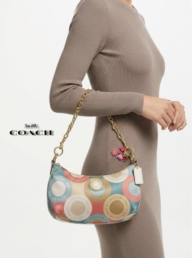 Coach Snaphead Demi Multicolor Satin Shoulder Bag (Category: Luxury Bags & Wallets) located in Cebu City. Submitted by gabgaaab (Listing ID 1466324392, Image 1). Description: - Coach Snaphead Demi Multicolor Satin Shoulder Bag - Excellent Condition - Style: Snaphead Demi Shoulder Bag - Material: Multicolor satin fabric with pastel circles and Coach lettering - Hardware: Gold-tone - Details: Includes pink flower charm and signature Coach hangtag -