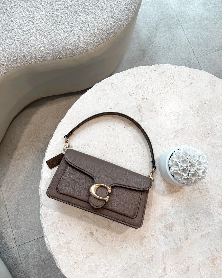 COACH TABBY SHOULDER BAG 26 – DARK STONE (Category: Luxury Bags & Wallets) located in Paranaque City. Submitted by j.tricianicoleanne (Listing ID 1466187351, Image 1). Description: Selling my Coach Tabby 26 in Brass/Dark Stone 🤎 ✨ Like New / Excellent Condition Very well kept and in beautiful condition. • Authentic Coach • Color: Brass/Dark Stone • Polished pebble leather • Signature Coach “C” hardware • Detachable short shoulder strap • Detacha