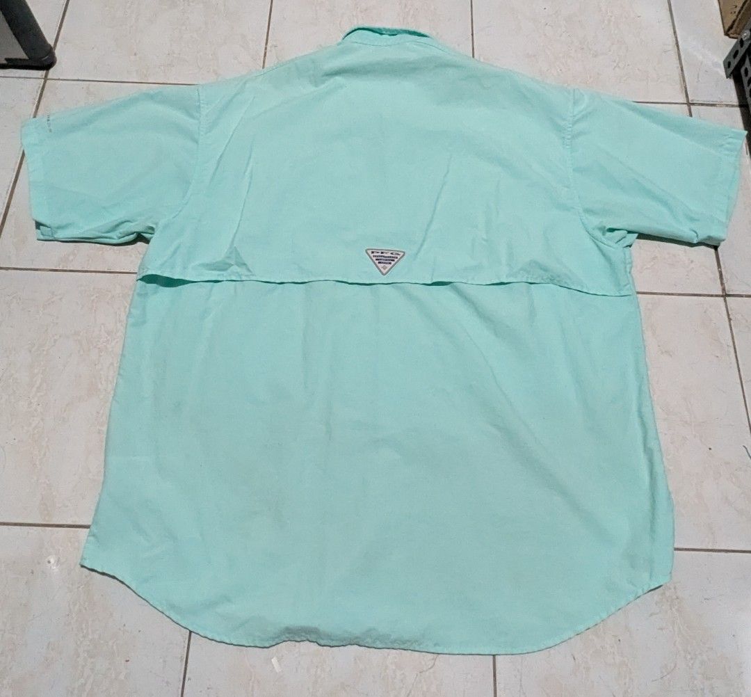 Columbia PFG shirt (Category: Tshirts & Polo Shirts ) located in Malabon City. Submitted by doobidoi (Listing ID 1466217197, Image 2). Description: - Brand/Model: Columbia PFG Fishing Shirt - Color: Light mint green - Size: Large - Width: 24" - Length: 29" Good condition - Closure: Button-up front - Features: Double chest pockets, rod holder loop, and mesh-lined upper back vent for airflow - Fabric: Lightweight and perfect for hot weather outdoor