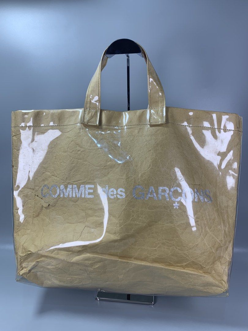 Comme des GARCONS PVC tote Bag (Category: Tote Bags) located in Mabalacat. Submitted by vtgmalan (Listing ID 1466285794, Image 2). Description: Brand : Comme des GARCONS PVC tote Bag Price: 3,500 Condition : Good Condition Product Condition Rank : B Issue/s : Tearing Kraft Paper and check all the photos Dimensions : 19.5 x 14 x 5 .5 (LxHxW) Inclusions: N/A Shipping Fee Shoulder By Buyer Note : Please make sure to check all the photos before mine.