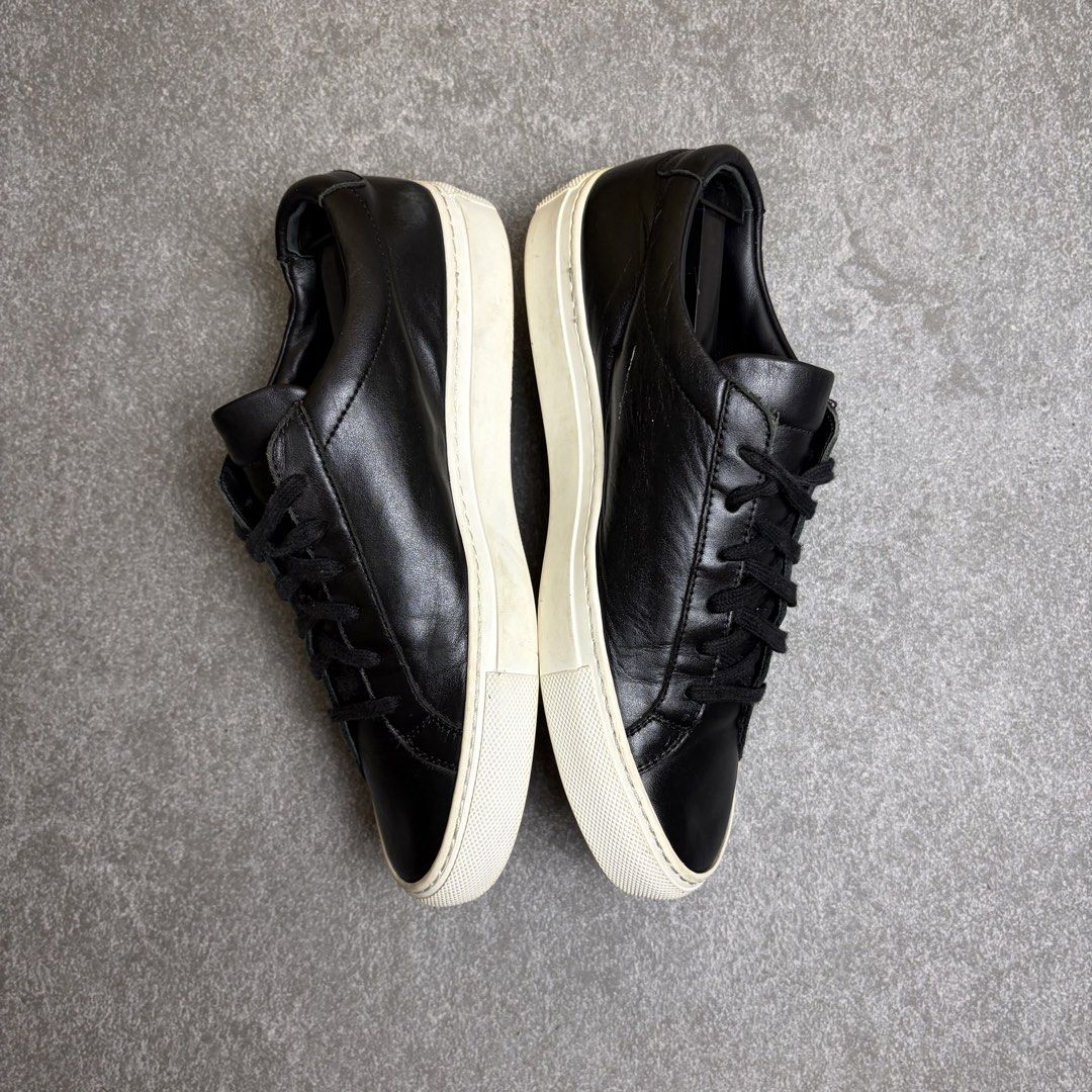 Common Projects Original Achilles Low Black Size 37 (Category: Sneakers) located in Cagayan de Oro. Submitted by taramattsa45690 (Listing ID 1466157767, Image 3). Description: Black leather low-top sneakers from Common Projects. Classic minimalist design with tonal laces and a contrasting white rubber sole. Gold serial number stamped on the heel counter. Leather upper and lining. Regular signs of wear on the soles and midsoles, uppers are clean a