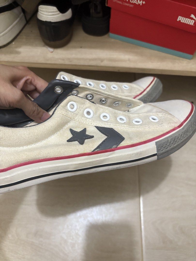 Converse Star Chevron Off-White Sneakers (Category: Sneakers) located in Mandaluyong City. Submitted by shopwithjuu (Listing ID 1466200389, Image 2). Description: Pre-loved off-white Converse canvas sneakers featuring the iconic dark grey star and chevron logo, with striking red and black midsole piping and ankle padding. Shows regular overall wear on the canvas and midsoles, and please note that laces are not included. Grab these classic kicks t