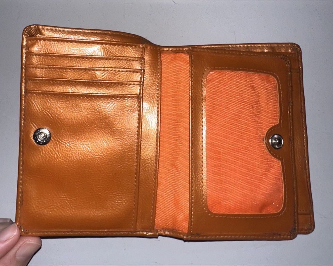 Courreges Vinyl Wallet (Category: Luxury Bags & Wallets) located in Davao. Submitted by buygenius (Listing ID 1466313293, Image 3). Description: • This vinyl Courreges wallet has 7 card slots, a coin purse, a slot for photos, and lots of slip pockets for receipts and other ephemera! The bill compartment is also divided into two sections in case you want to separate some bills. Color is even more eye-catching and playful IRL! • Flaws: due to the v