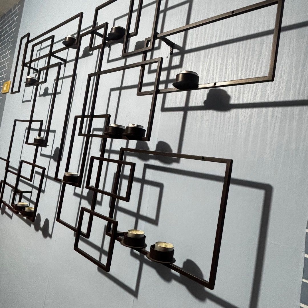 Crate & Barrel Circuit Pewter Wall Candle Holder (Category: Wall Decor) located in Caloocan City. Submitted by crateandbarrel (Listing ID 1466323936, Image 1). Description: Large geometric metal wall art piece with built-in candle holders and glass cylinders. Dark bronze or black finish. Creates cool shadow patterns on the wall when candles are lit. Heavy piece, needs proper wall anchors to hang securely. Minimalist modern style, great statement 