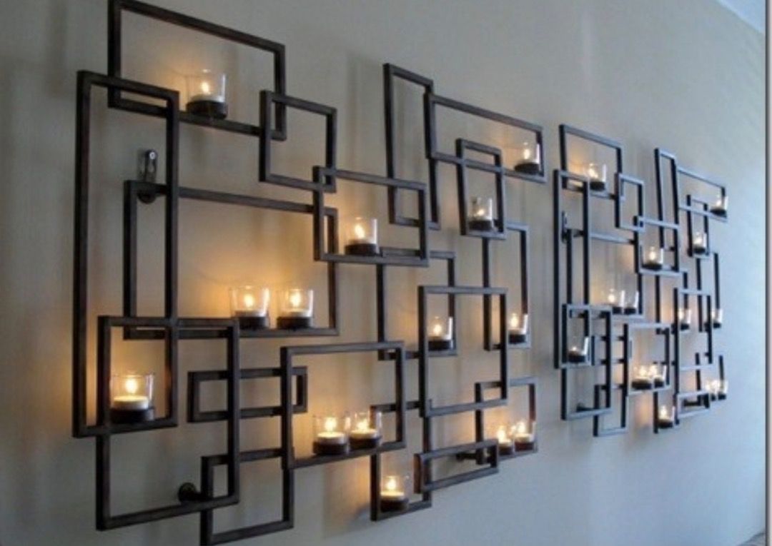 Crate & Barrel Circuit Pewter Wall Candle Holder (Category: Wall Decor) located in Caloocan City. Submitted by crateandbarrel (Listing ID 1466323936, Image 2). Description: Large geometric metal wall art piece with built-in candle holders and glass cylinders. Dark bronze or black finish. Creates cool shadow patterns on the wall when candles are lit. Heavy piece, needs proper wall anchors to hang securely. Minimalist modern style, great statement 