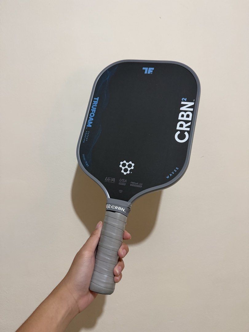 CRBN TRUFOAM Waves Pickleball Paddle (Category: Racket and Ball Sports) located in Las Pinas. Submitted by 2580cart (Listing ID 1466289619, Image 1). Description: - Model: CRBN2 TRUFOAM Waves pickleball paddle - Condition: Flawless, zero scuffs on the carbon face - Edge Guard: Completely clean all around - Extras: Includes original branded protective cover sleeve and wrapped grip handle Bought last February 2026.