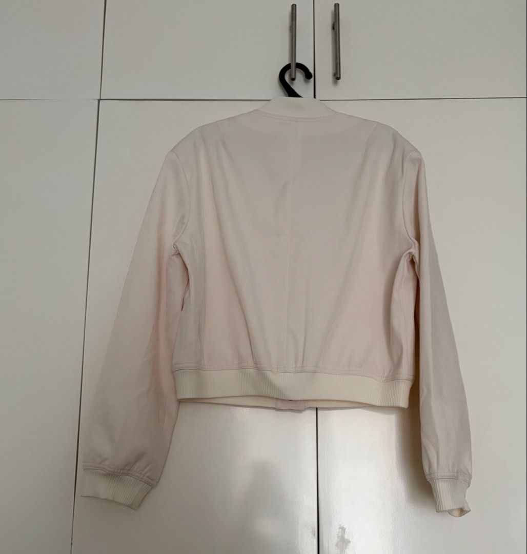 Cream Bomber Jacket with Front Pockets Size S (Category: Coats, Jackets and Outerwear) located in Las Pinas. Submitted by sabs28 (Listing ID 1466237282, Image 2). Description: Features a button-up front, two large chest pockets, and ribbed details. 100% polyester. .