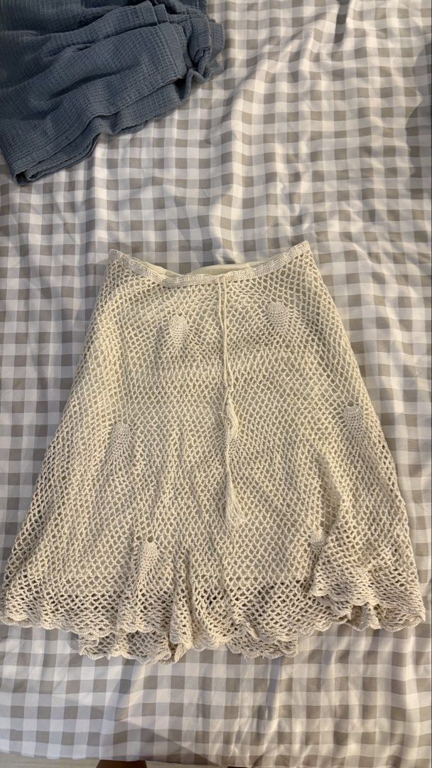 Cream Crochet Knit Skirt with Lining and Drawstring (Category: Skirts) located in Muntinlupa City. Submitted by addielejano (Listing ID 1466266967, Image 1). Description: Cream crochet knit skirt. Fully lined underneath so it's not see-through. Open mesh pattern with solid pineapple motifs scattered throughout. Scalloped hem at the bottom. Drawstring waist with tassel ends. Midi length, flowy fit. fits M-L.