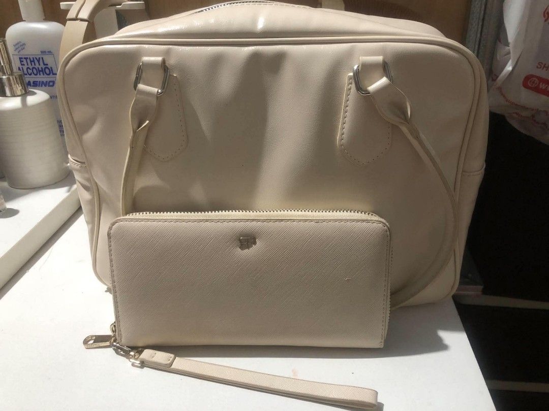 Cream Handbag and Matching Wallet Set (Category: Luxury Bags & Wallets) located in Manila. Submitted by camron08 (Listing ID 1466310647, Image 1). Description: - Color: Neutral off-white / cream - Set includes: Large shoulder bag and matching wristlet wallet - Bag features: Structured handles and a spacious interior for daily essentials - Wallet features: Textured Saffiano-style finish, card slots, clear ID window, and zippered coin pocket - Cond