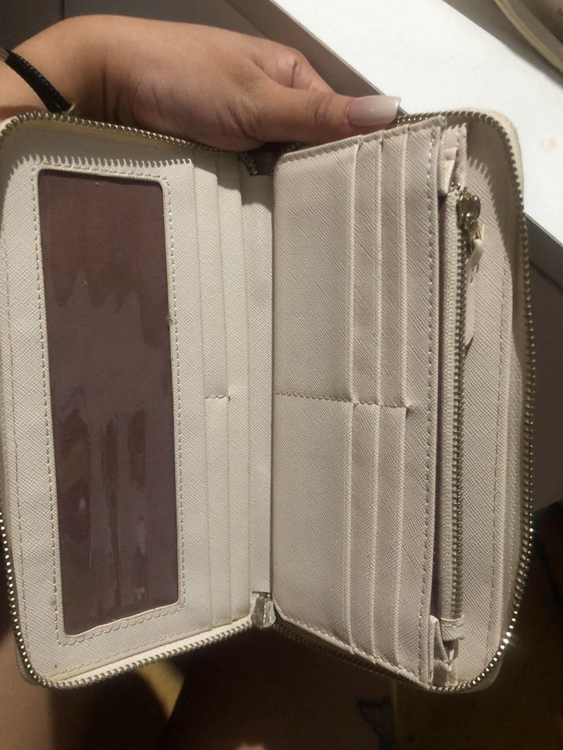 Cream Handbag and Matching Wallet Set (Category: Luxury Bags & Wallets) located in Manila. Submitted by camron08 (Listing ID 1466310647, Image 2). Description: - Color: Neutral off-white / cream - Set includes: Large shoulder bag and matching wristlet wallet - Bag features: Structured handles and a spacious interior for daily essentials - Wallet features: Textured Saffiano-style finish, card slots, clear ID window, and zippered coin pocket - Cond