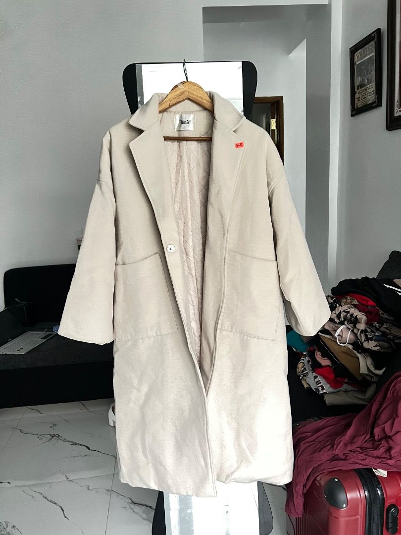 Cream Quilted Lined Long Trench Coat wool Outerwear (Category: Coats, Jackets and Outerwear) located in Baguio. Submitted by pureearth.5f1c08 (Listing ID 1466228543, Image 1). Description: - Color: Cream / Neutral Beige -size: Small-Large - Style: Long coat with snap button front closure - Warmth: Quilted interior lining for extra warmth - Storage: Two functional front pockets - Detail: Small black label on the right sleeve cuff - Condition: Exce