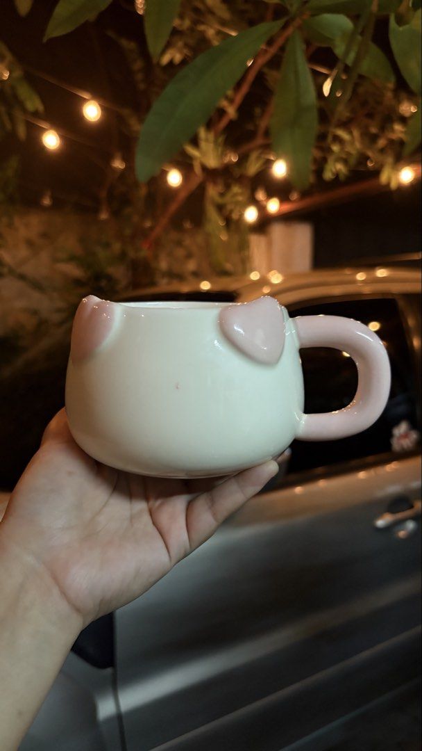 Cute ceramic mug with pink heart ears and handle (Category: Coffee & Tea Tableware) located in Manila. Submitted by mug.aras (Listing ID 1466313335, Image 1). Description: Charming white ceramic mug with pink heart details and a matching pink handle. Features a comfortable rounded shape and smooth hand-glazed finish, perfect for your daily coffee or tea..