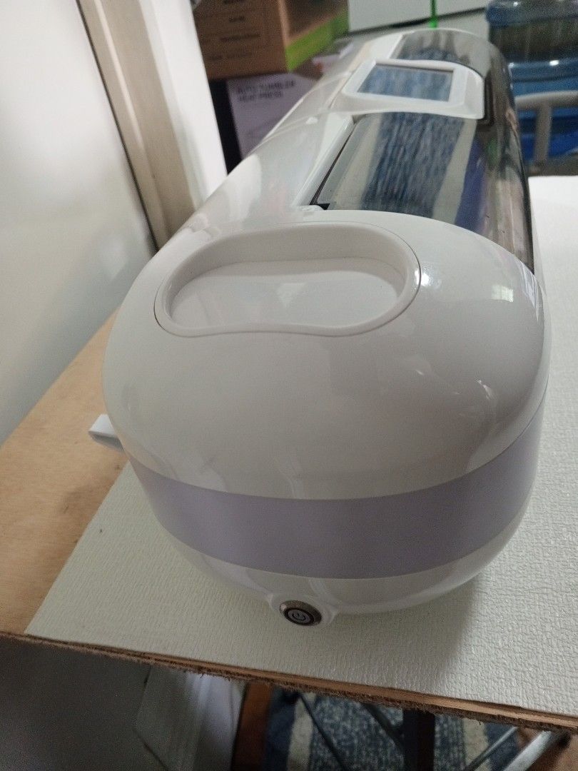 Cuyi Mini Electronic Cutting Machine (Category: Craft Supplies & Tools) located in Caloocan City. Submitted by sycris25 (Listing ID 1466201898, Image 3). Description: - Brand: Cuyi Mini cutting machine - Ideal for crafts and vinyl projects - Compact white unit with dark tinted protective cover - Features a top digital control screen and side power button - Built-in roller mechanisms for smooth material feeding - Clean surface with no major scuffs