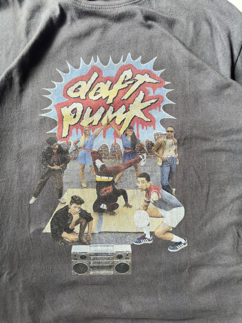 DAFT PUNK (Category: Tshirts & Polo Shirts ) located in Davao. Submitted by kelsocool (Listing ID 1466256169, Image 3). Description: Daft Punk Breakdance Graphic Tee Dimes (inch): 25 - length 21 - width 8.5 - sleeve color rate: 9/10 no issue good condition Model: 5’5 ft/ 54 kg Description: Heavy retro graphic featuring b-boy breakdance artwork with Daft Punk block typography on a faded charcoal blank. Clean oversized str.
