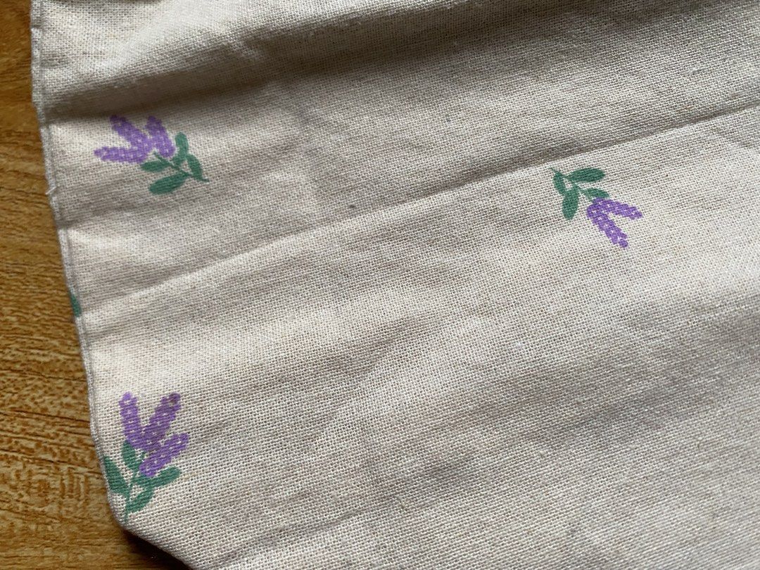 Daiso® Purple Floral Linen Drawstring Pouch (Category: Backpacks) located in Cainta. Submitted by stuff_4_sale_dump (Listing ID 1466201702, Image 2). Description: - original tag attached - 25cm W x 17cm H - for organizing makeup, accessories, or travel essentials.